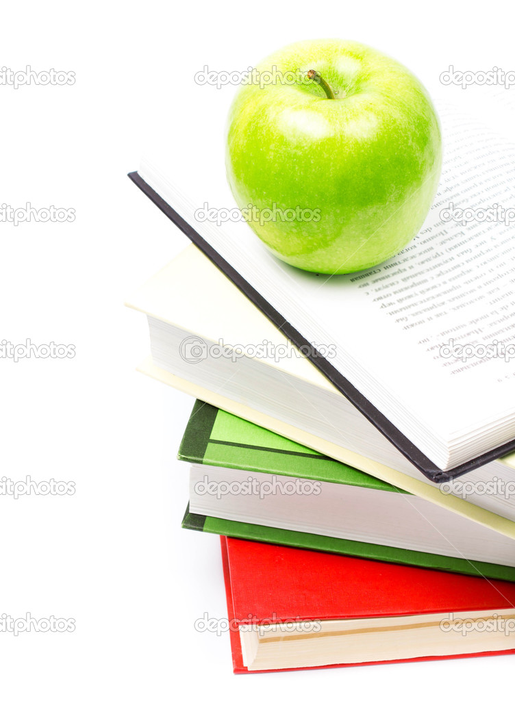 School supplies composition in classroom with books and apple