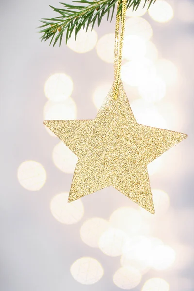 Christmas card with golden star and pine branch — Stock Photo, Image