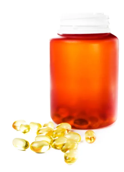 Shiny yellow vitamin E omega 3 fish oil capsules and pill bottle — Stock Photo, Image