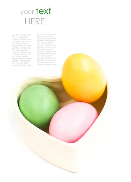 Heart shaped box full of colorful eggs — Stock Photo, Image