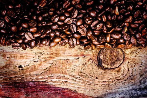 Coffee beans on old natural wooden background — Stock Photo, Image