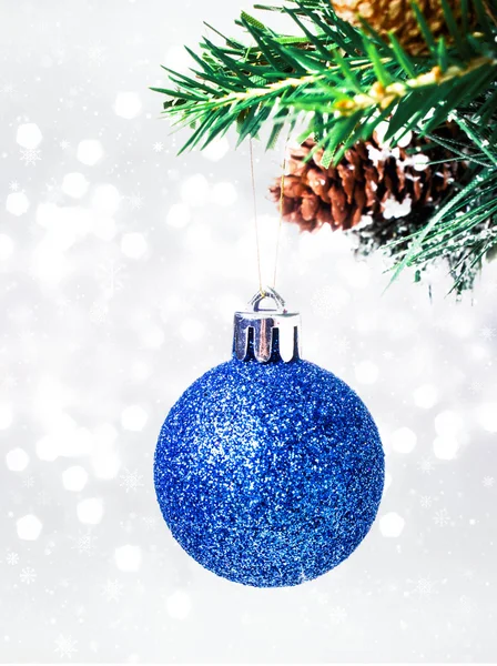 Christmas card with blue hanging ball and pine branch — Stock Photo, Image