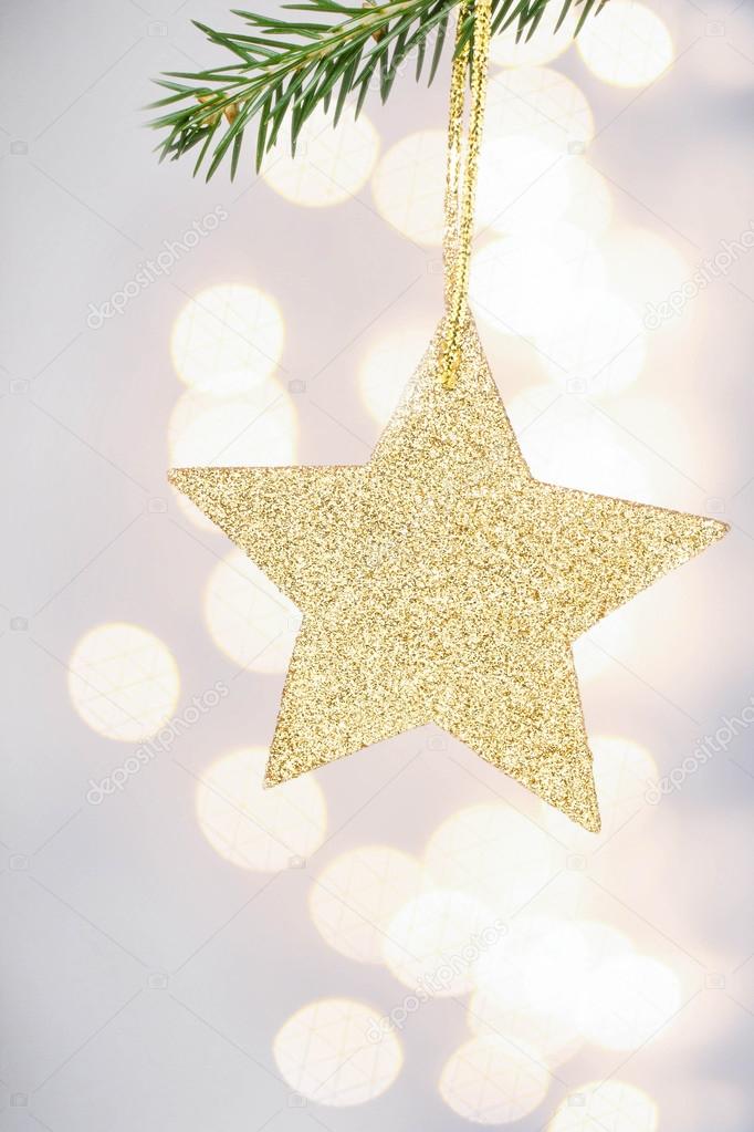 Christmas card with golden star and pine branch