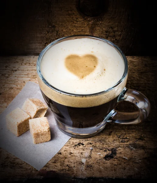 Coffee in glass with heart foam — Stock Photo, Image