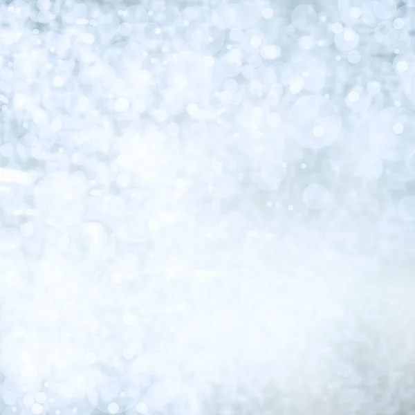 Bright and festive silver background with snow flakes, stars and bokeh