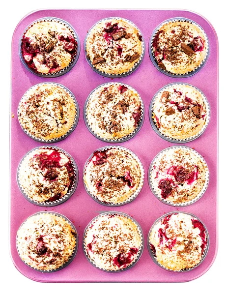 Muffins with Chocolade and Cherry in a pink colored baking tray — Stock Photo, Image