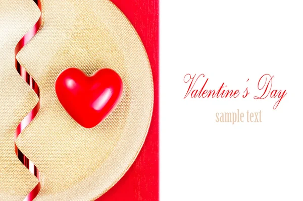 Red Heart on golden plate on red tablecloth — Stock Photo, Image