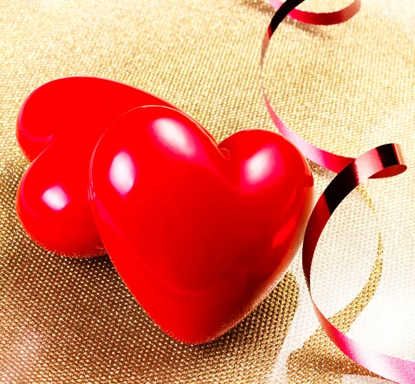 Two Red Hearts on golden plate — Stock Photo, Image