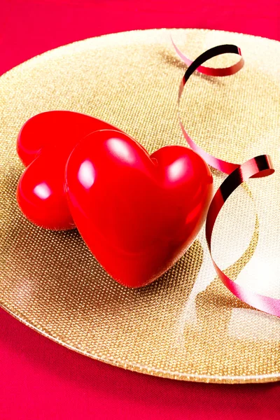 Two Red Hearts on golden plate — Stock Photo, Image