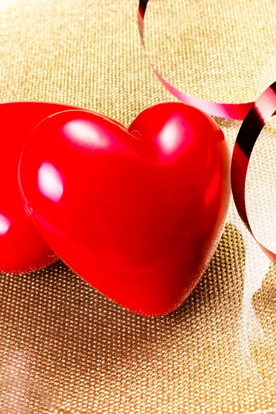 Two Red Hearts on golden plate close up — Stock Photo, Image