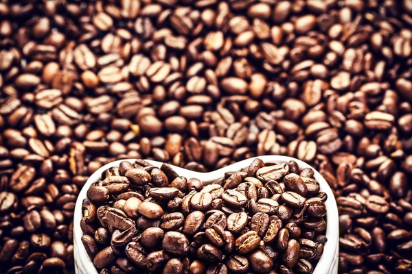 Roasted Coffee Beans in a Heart shaped bowl — Stock Photo, Image