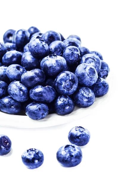 Fresh blueberries on white plate — Stock Photo, Image