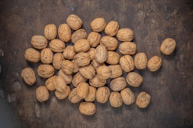 Ripe Walnuts on a wooden table.  Walnut fresh nuts Background top vie