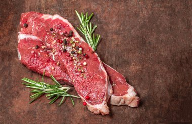 Fresh raw beef steak meat on old wooden table. Copyspace. Top vie