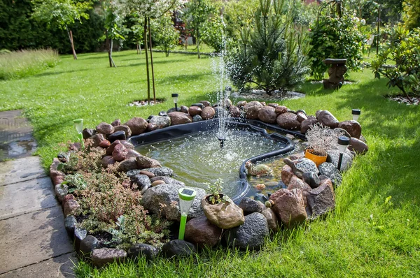 Fountain in field — Stock Photo, Image