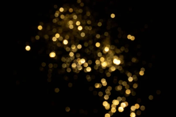 Golden blurred bokeh lights on black background — Stock Photo, Image