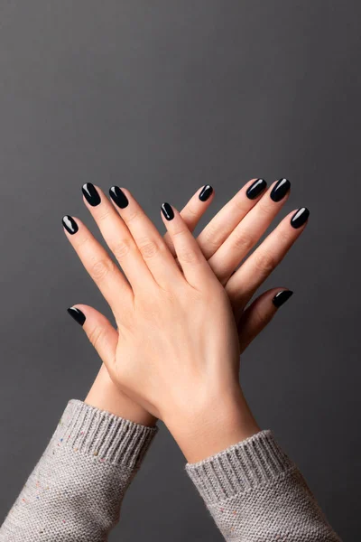 Female hands with black nails