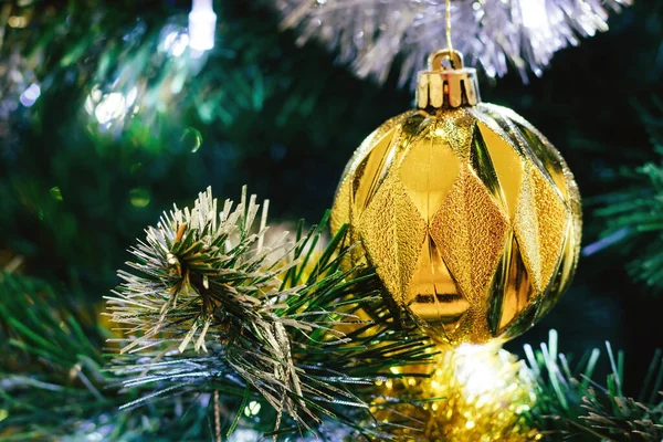 Golden ball on Christmas tree — Stock Photo, Image