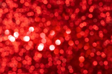Kırmızı ışıltılı ışıltılı arka plan, soyut noel odaklı olmayan doku. Tatil ışıkları
