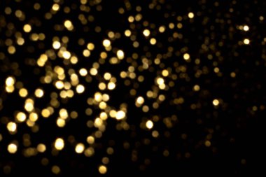Siyah arkaplanda altın bulanık bokeh ışıkları
