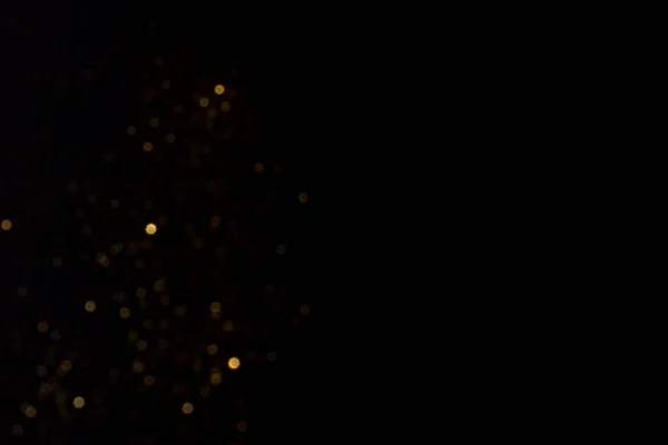 Arany homályos bokeh fények fekete háttér — Stock Fotó