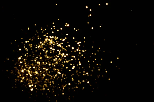 Golden blurred bokeh lights on black background — Stock Photo, Image