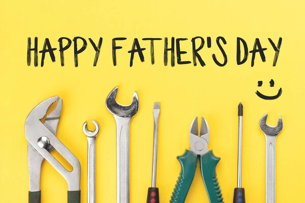 Work tools on yellow background. Happy fathers day concept