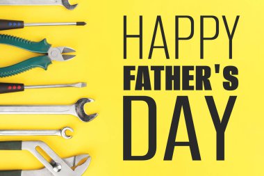 Work tools on yellow background. Happy fathers day concept
