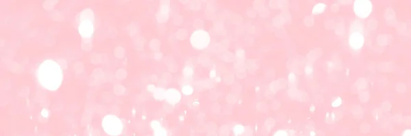 Pink sparkling glitter bokeh background, banner texture. Abstract defocused lights header. Wide screen wallpaper. Panoramic web banner with copy space for design
