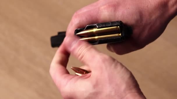 男性手从卡拉什尼科夫冲锋枪弹药库卸下子弹 带有7 62口径子弹的弹药库 用于Ak 47特写镜头 — 图库视频影像