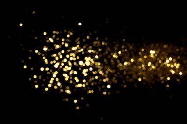 Siyah arka planda altın bulanık bokeh ışıkları. Kutlamak için ışıldayan yıldızlar. Tasarımınız için üstüste