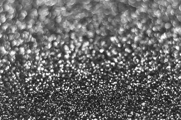 Gray silver sparkling glitter bokeh background, christmas abstract defocused texture. Holiday lights. Snowy shiny sparkle stars for celebrate