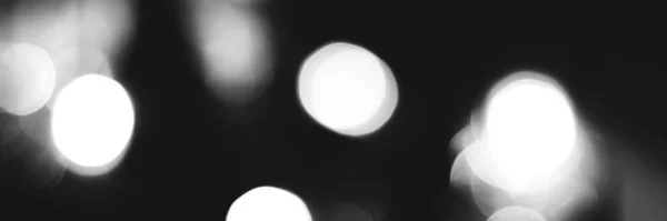 Blurred lights black and white background, banner texture. Abstract bokeh with soft light header. Wide screen wallpaper. Panoramic web banner with copy space for design