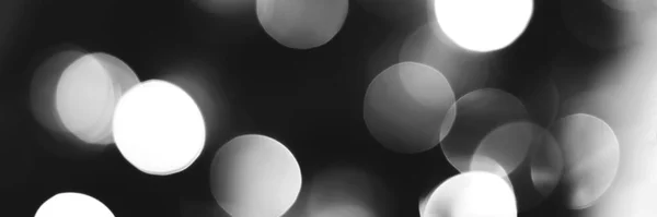 Blurred lights black and white background, banner texture. Abstract bokeh with soft light header. Wide screen wallpaper. Panoramic web banner with copy space for design