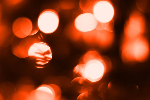 Blurred lights, dark orange background. Abstract bokeh with soft light