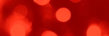Blurred lights red background, banner texture. Abstract bokeh with soft light header. Wide screen wallpaper. Panoramic web banner with copy space for design