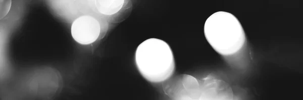 Blurred lights black and white background, banner texture. Abstract bokeh with soft light header. Wide screen wallpaper. Panoramic web banner with copy space for design