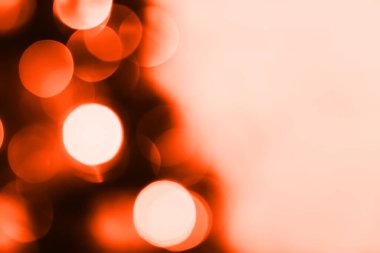 Blurred lights, dark orange background. Abstract bokeh with soft light