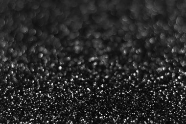 Gri, parlak, ışıl ışıl parlak arka plan, noel soyut, odağını kaybetmiş doku. Tatil ışıkları. Kutlamak için karlı, parlak yıldızlar.