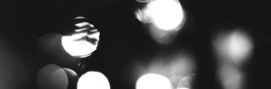 Blurred lights black and white background, banner texture. Abstract bokeh with soft light header. Wide screen wallpaper. Panoramic web banner with copy space for design