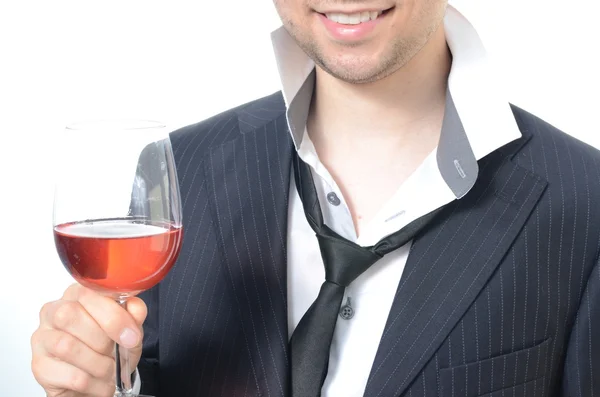 Joven empresario bebiendo vino — Foto de Stock