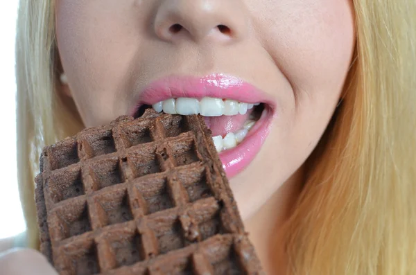 Jovem mulher comendo waffle de chocolate — Fotografia de Stock