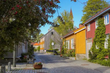 Street in Bakklandet, popular touristic district in the Norwegian city Trondheim  clipart