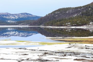 Norveç 'te bahar mevsimi, Trondelag' da yer alan Vaavatnet Gölü 'ndeki eriyen karın manzarası.