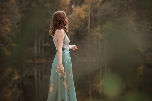 Orman gölünde duran bir kızın sonbahar portresi. Telifsiz Stok Imajlar