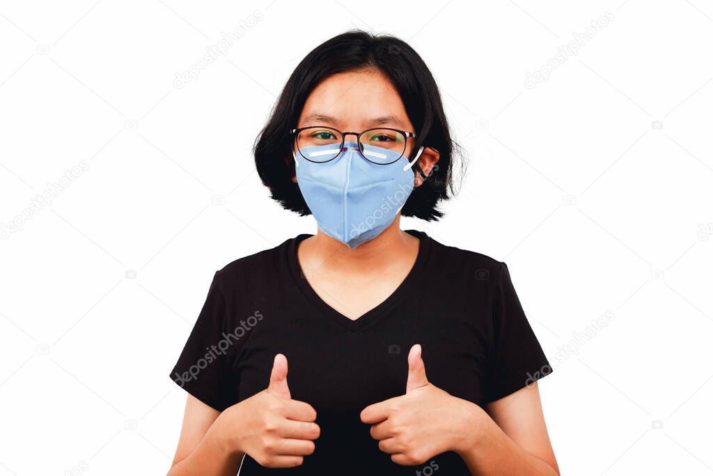 Young girl wear mask and thump up to flighting corona virus or Covid-19