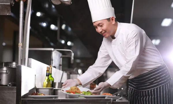 Food occupation, professional chef cook the food in kitchen, chef preparing food in the kitchen of a restaurant