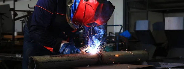 Close up welding spatter from arc welding, industrial concpet , welder is welding metal part factory