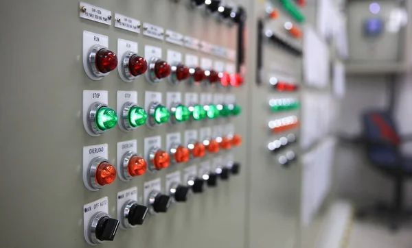 Closeup of lights and machine control dials on manufacturing machinery