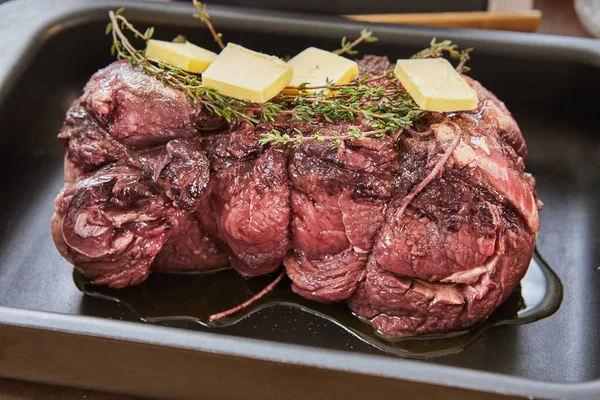 Beef with rosemary and butter is ready for baking in the oven — Stock Photo, Image